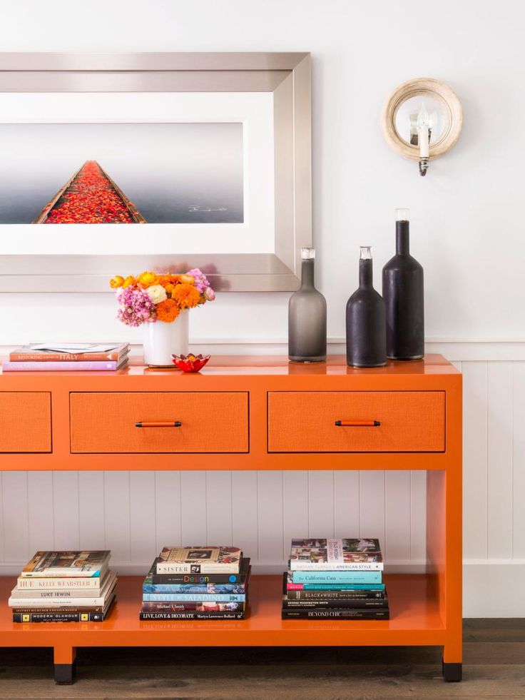 Colorful orange console table for entryway