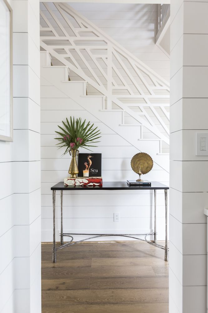 Custom coastal-inspired stairwell + white shiplap walls + wide plank wood floors...