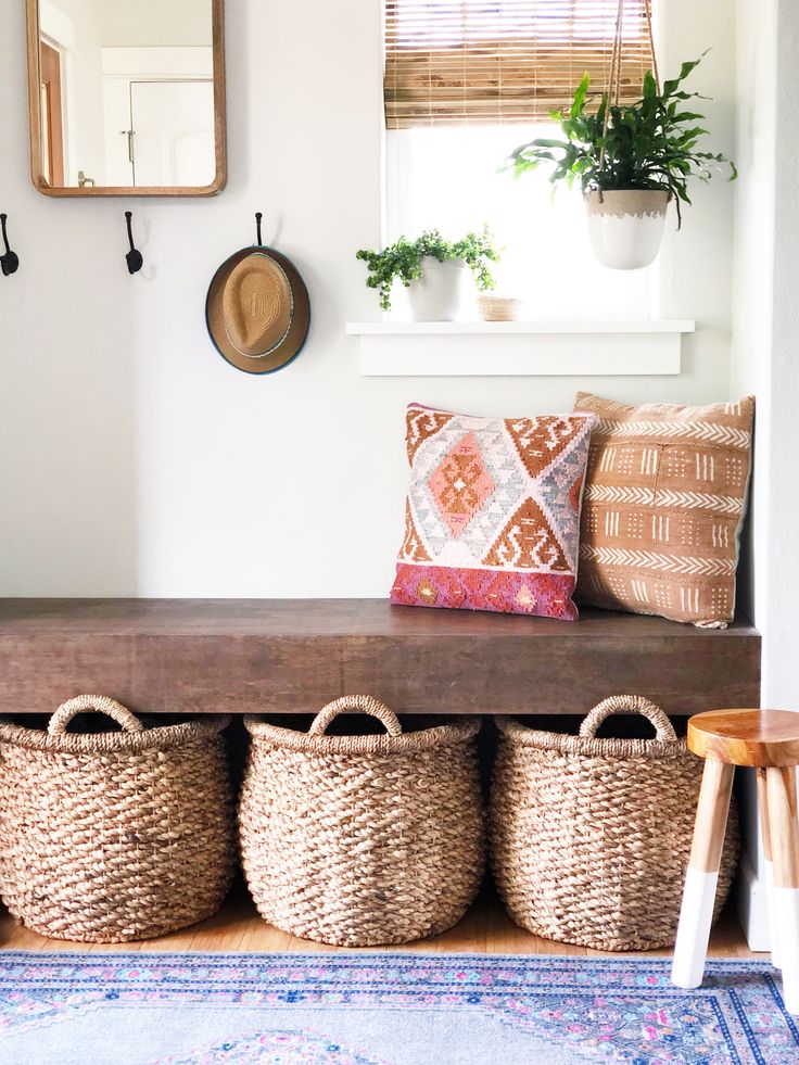 Global style entryway with baskets under bench
