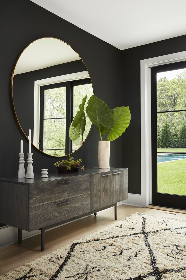 Black walls with dark stained console table