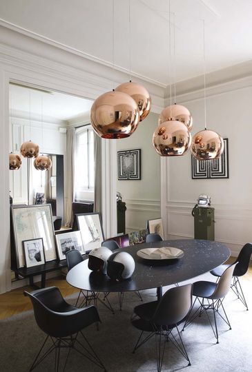 Elegant dining area, pendants by Tom Dixon. Via Côté Maison. Photo by Jean-Mar...