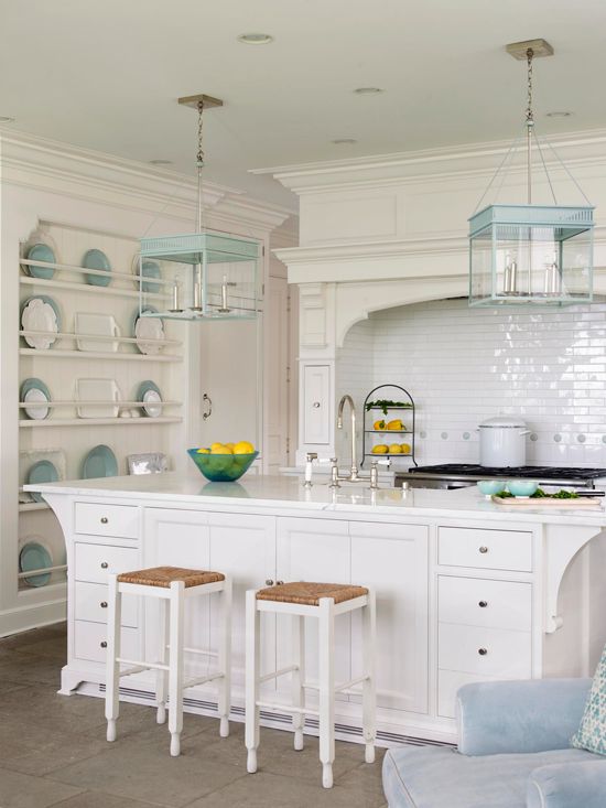...white kitchen with accents of pale aqua on light fixtures, small dot tiles in...