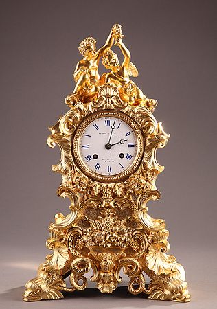 A French 19th century ormolu clock in rococo style ornate