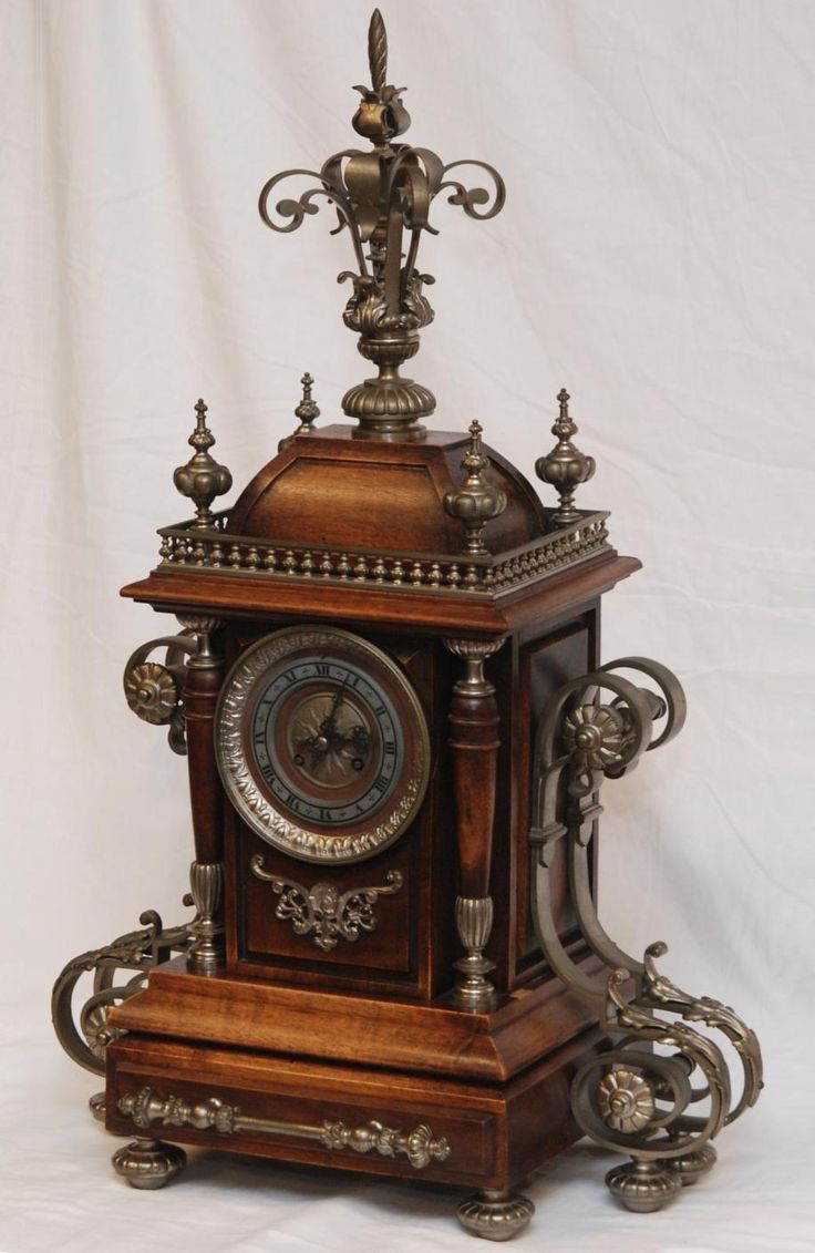 Antique French wooden mantle clock with silvered...
