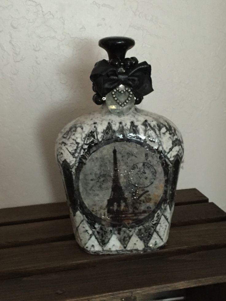 Crown royal bottle spray painted and decoupage with decorations