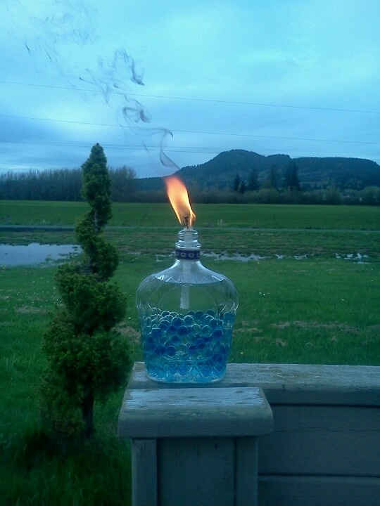 My home made tiki torches. I used Crown Royal bottles, Tiki replacement wiks, an...