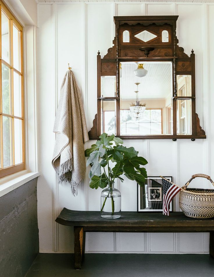 Antique statement mirror over a wood bench + how to style an entryway + mirror i...