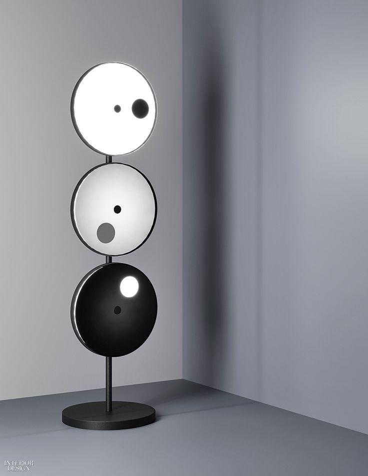 Eclipses inspired Os & Oos to give this floor lamp glass-disk diffusers that rot...