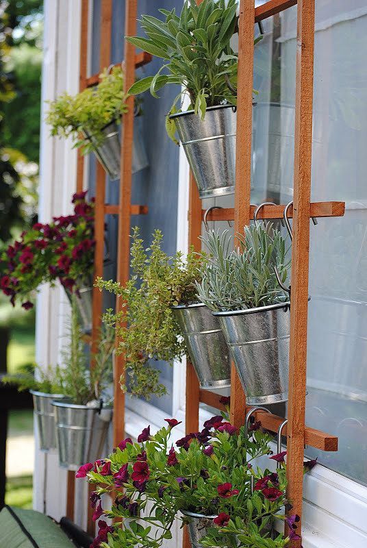 A basic trellis and a few hanging planters (how pretty are the silver buckets?!)...