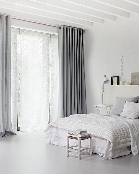 White bedroom with grey curtains