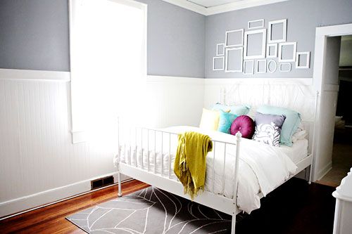 love the grey walls + pop of color pillows + rug.
