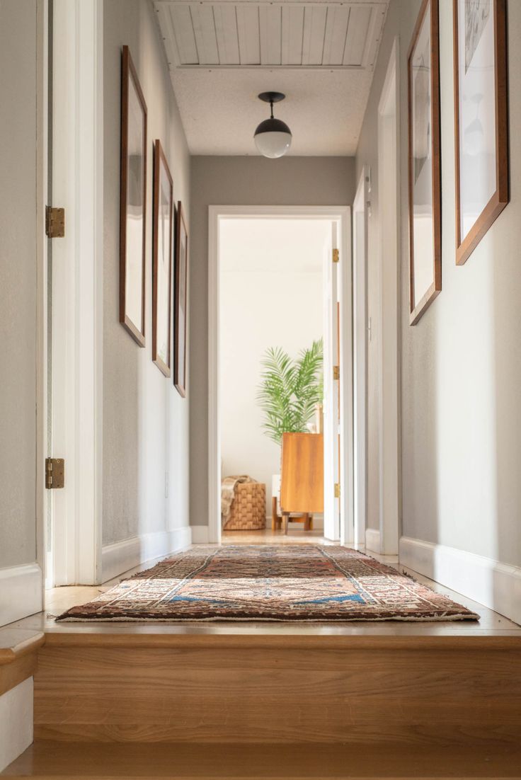 This modern hallway remodel features a travel gallery (and DIY photo mats!), Per...