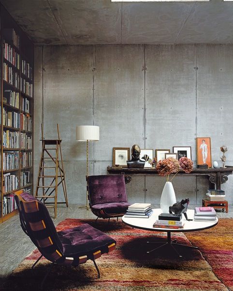 Concrete walls, rugs, book shelf, study, living room