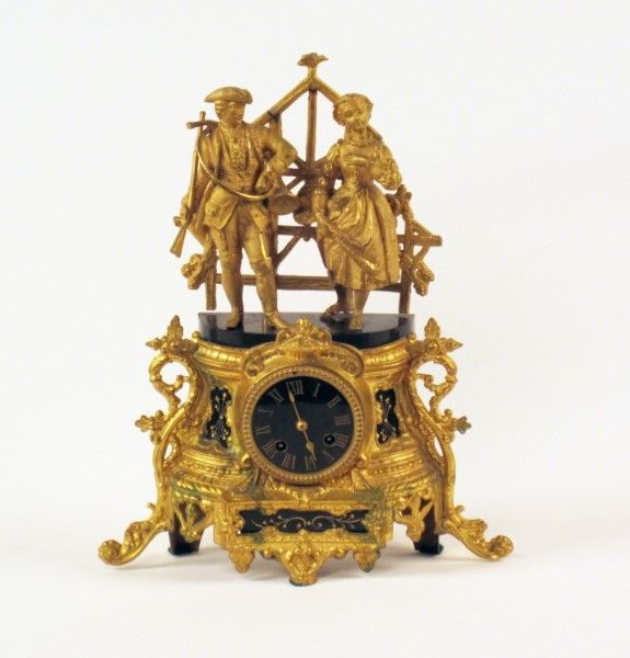 FRENCH GILT METAL AND ONYX MANTEL CLOCK HAVING FIGURAL MOUNT OF COSTUMED HUNTER ...