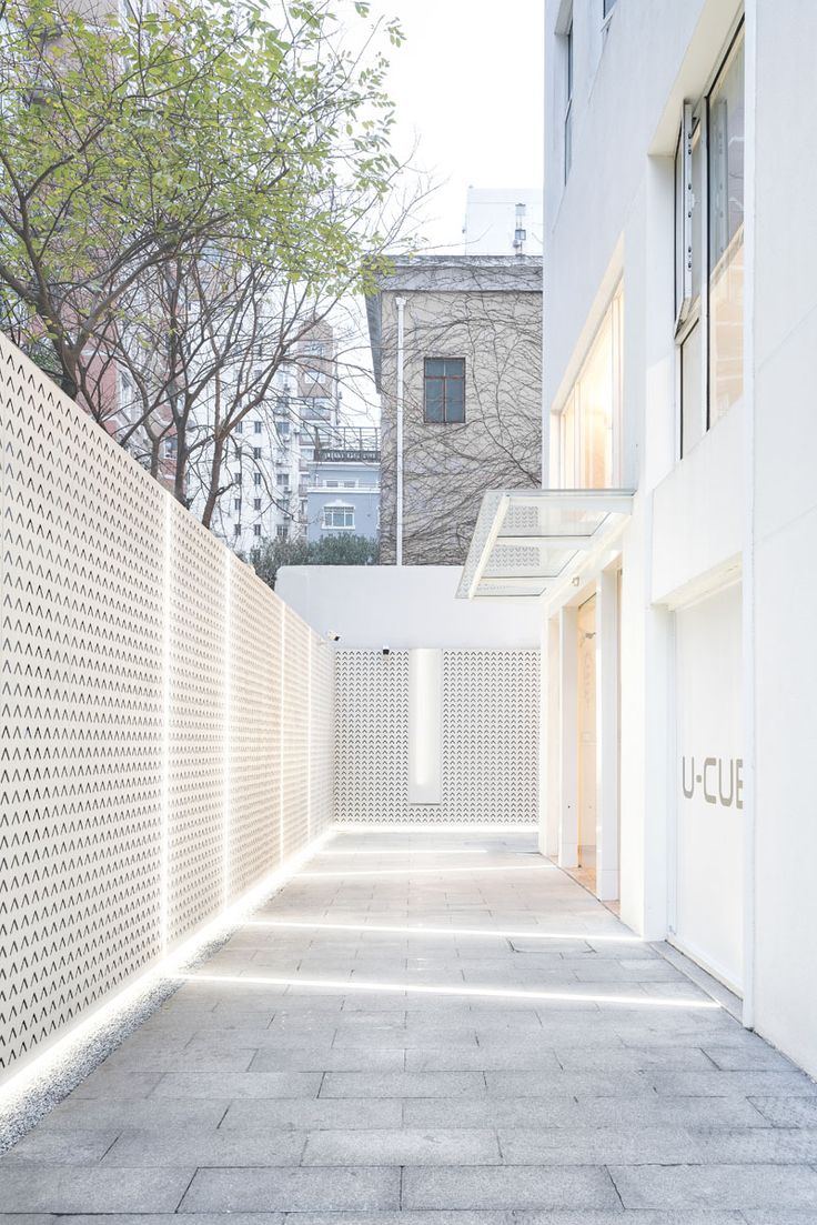 To brighten up an alleyway, lighting runs from the building, across the ground, ...