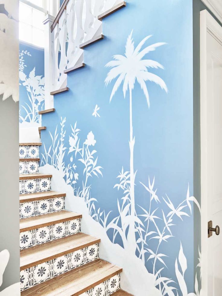 Blue and white staircase with tile risers and palm tree wallpaper in Palm Beach ...