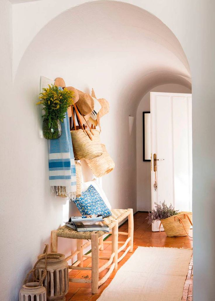 Woven bench in entry with wall hooks