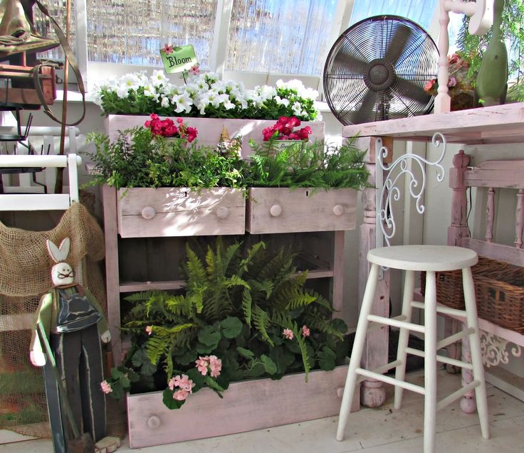 How whimsical.. and old chest of drawers as a vertical planter!