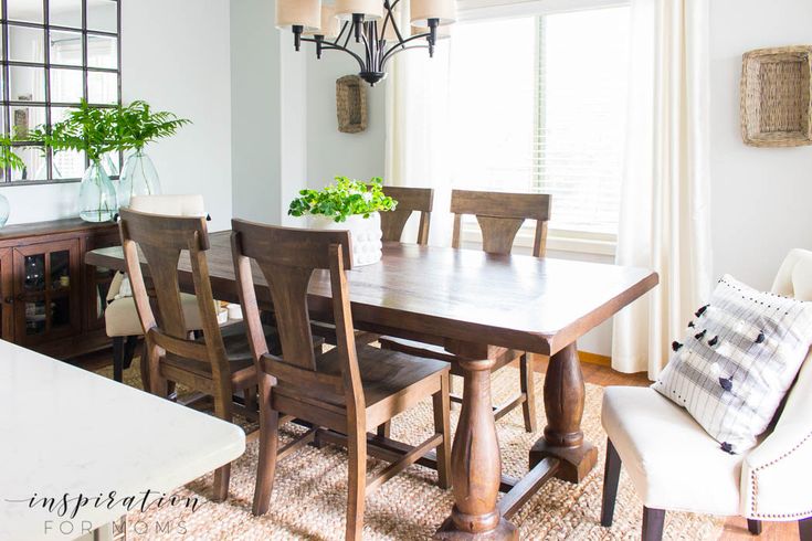 simple summer dining room decor with rustic farmhouse table and green plants