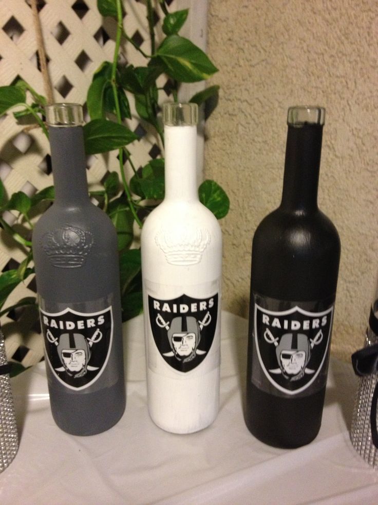 Painted Wine Bottles with team decal used as decor for a Raiders themed party.