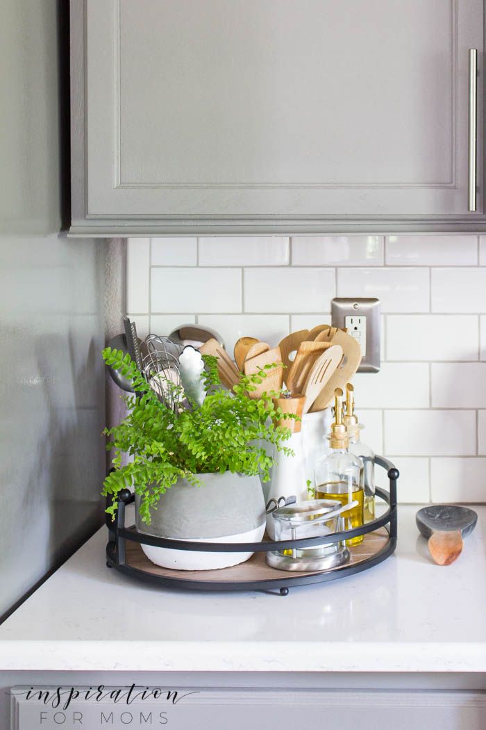 simple summer kitchen decor with wood tray and gray cabinets subway tile