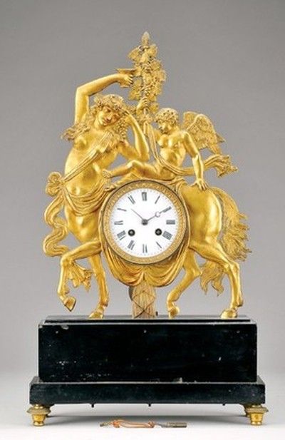 Brass table clock with mythological theme, mounted on black marble. French movem...