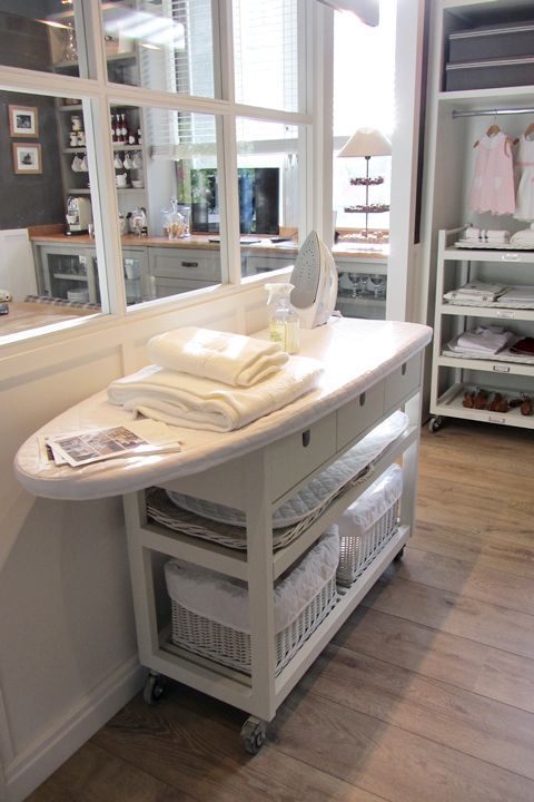 Take a IKEA kitchen island and attach an ironing board. Great space saving stora...