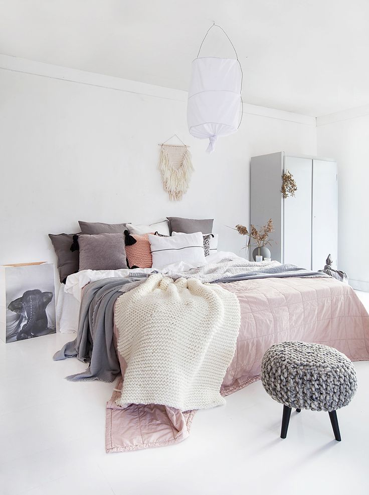 I love the knitted foot stool!  Norwegian Bedroom design - white walls and floor...