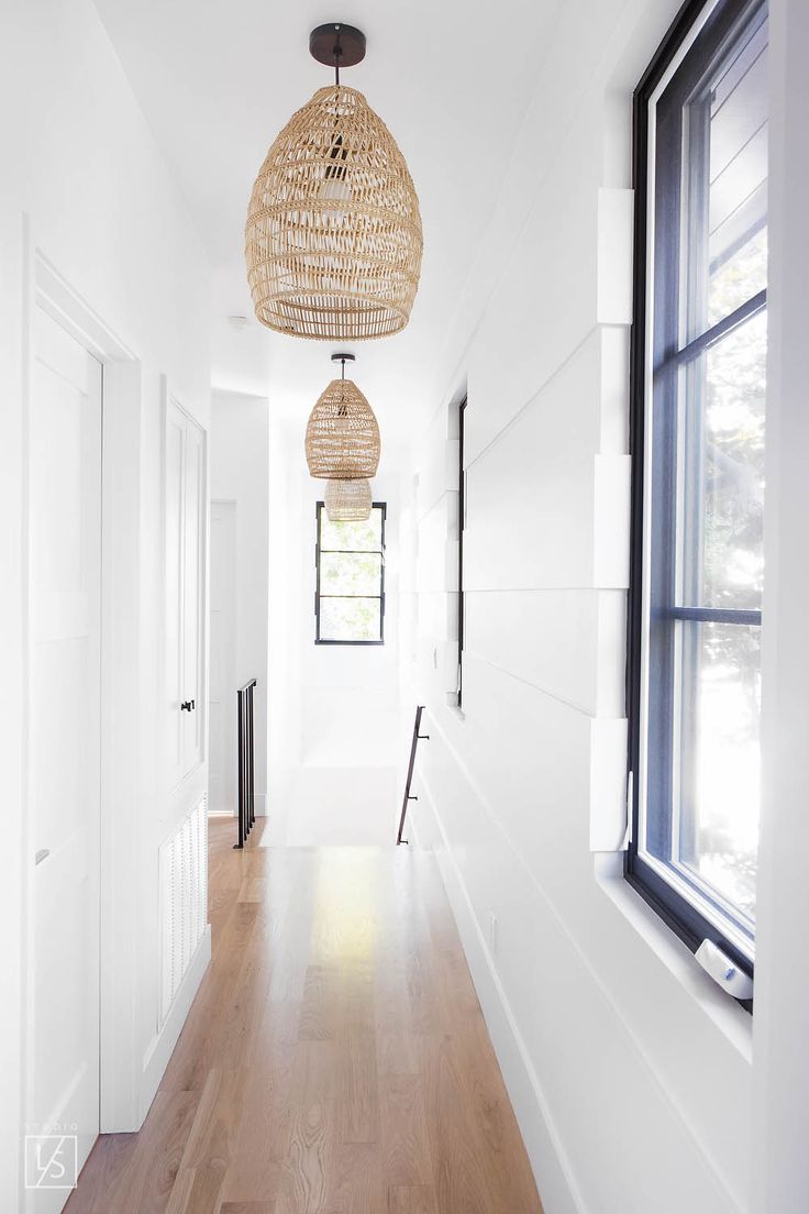 berwick // white paneled hallway // rattan basket hanging pendant // steel windo...