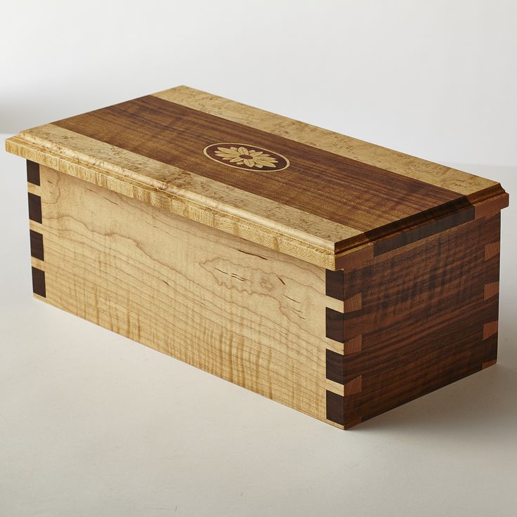 Curly walnut and curly maple box with dovetail joints and inlaid wood medallion.
