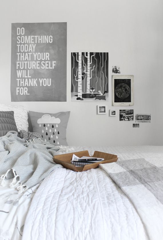 white and grey bedroom. posters.