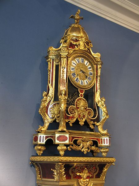 A Louis XIV gilt bronze mounted brass-inlaid tortoiseshell cartel clock and pede...
