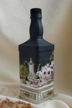 What looks like a Jack Daniels bottle or similar painted and decoupaged to make ...