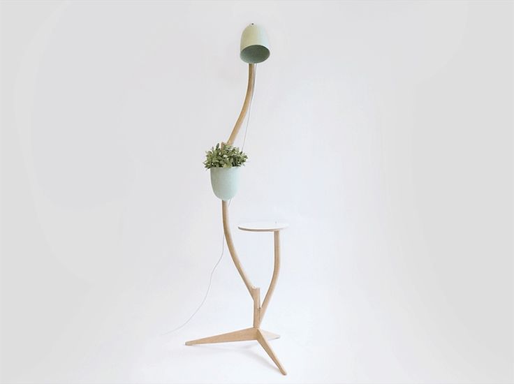 This whimsical piece of furniture is a lamp, table, and flowerpot in one
